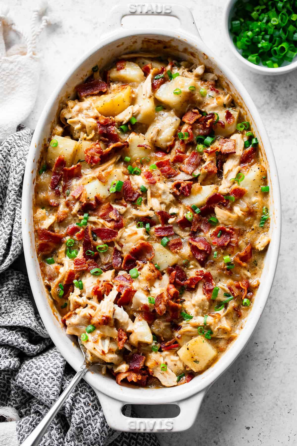 Overhead view of dairy-free chicken and potato casserole with crispy bacon