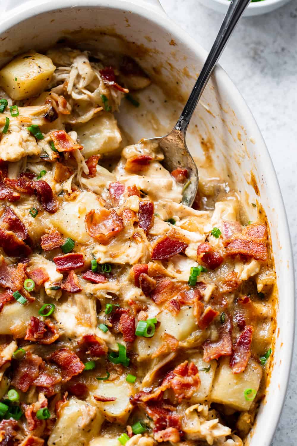 This savory creamy chicken potato casserole is the perfect healthy comfort food for cold winter nights! Hearty roasted potatoes are baked with chicken, bacon, and a creamy sauce that you won’t believe is dairy free. It’s kid approved, easy to make and the leftovers are perfect for a filling lunch the next day. It’s Whole30 compliant and paleo friendly. #paleo #whole30 #dairyfree #cleaneating
