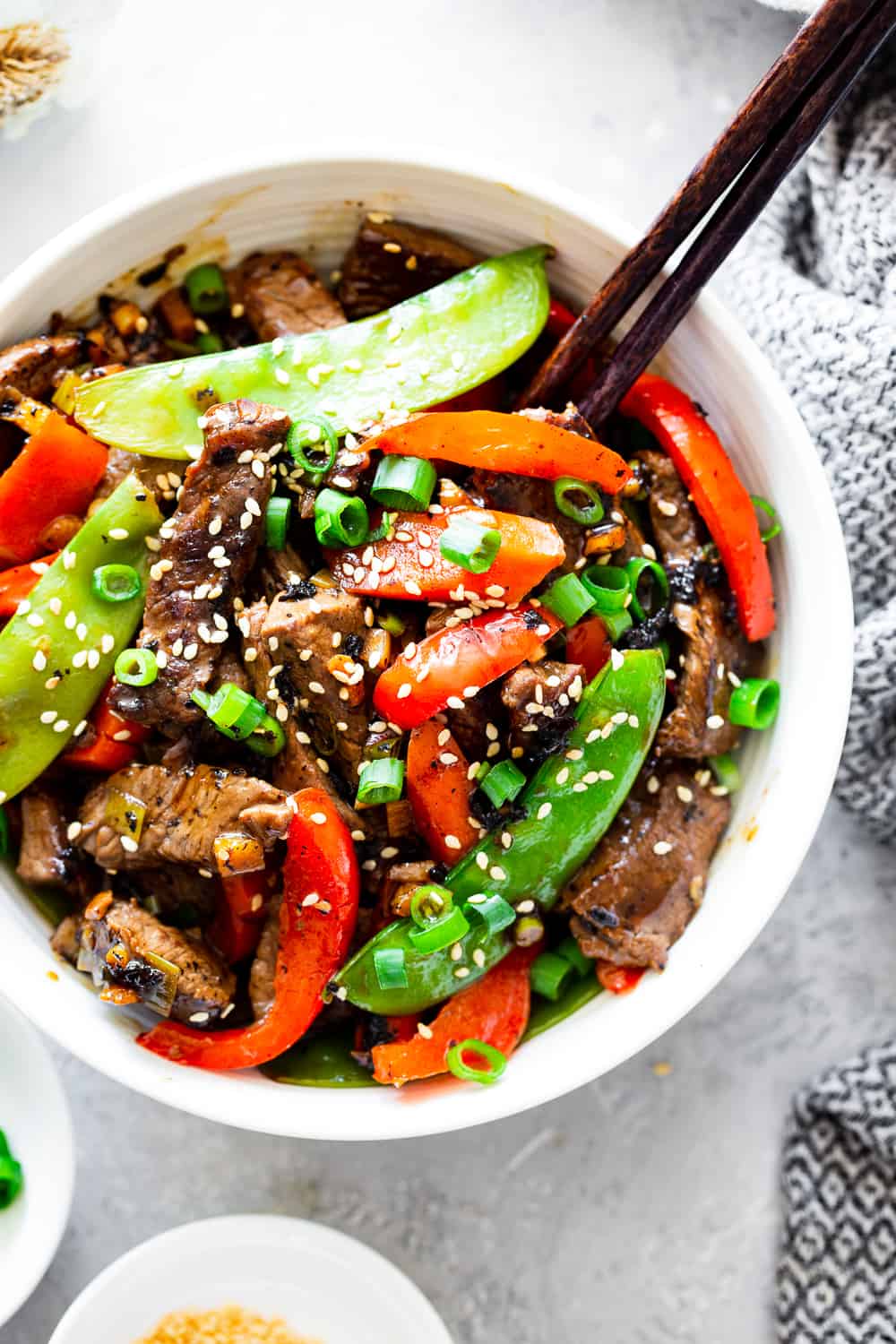 This quick and tasty paleo beef stir fry is loaded with flavor and veggies and uses clean simple ingredients. It’s so much healthier than takeout but just as fast! Family approved and great for weeknight dinners. I love serving it over fried cauliflower rice to keep it paleo, Whole30 compliant and low carb too. #paleo #whole30 #lowcarb #keto