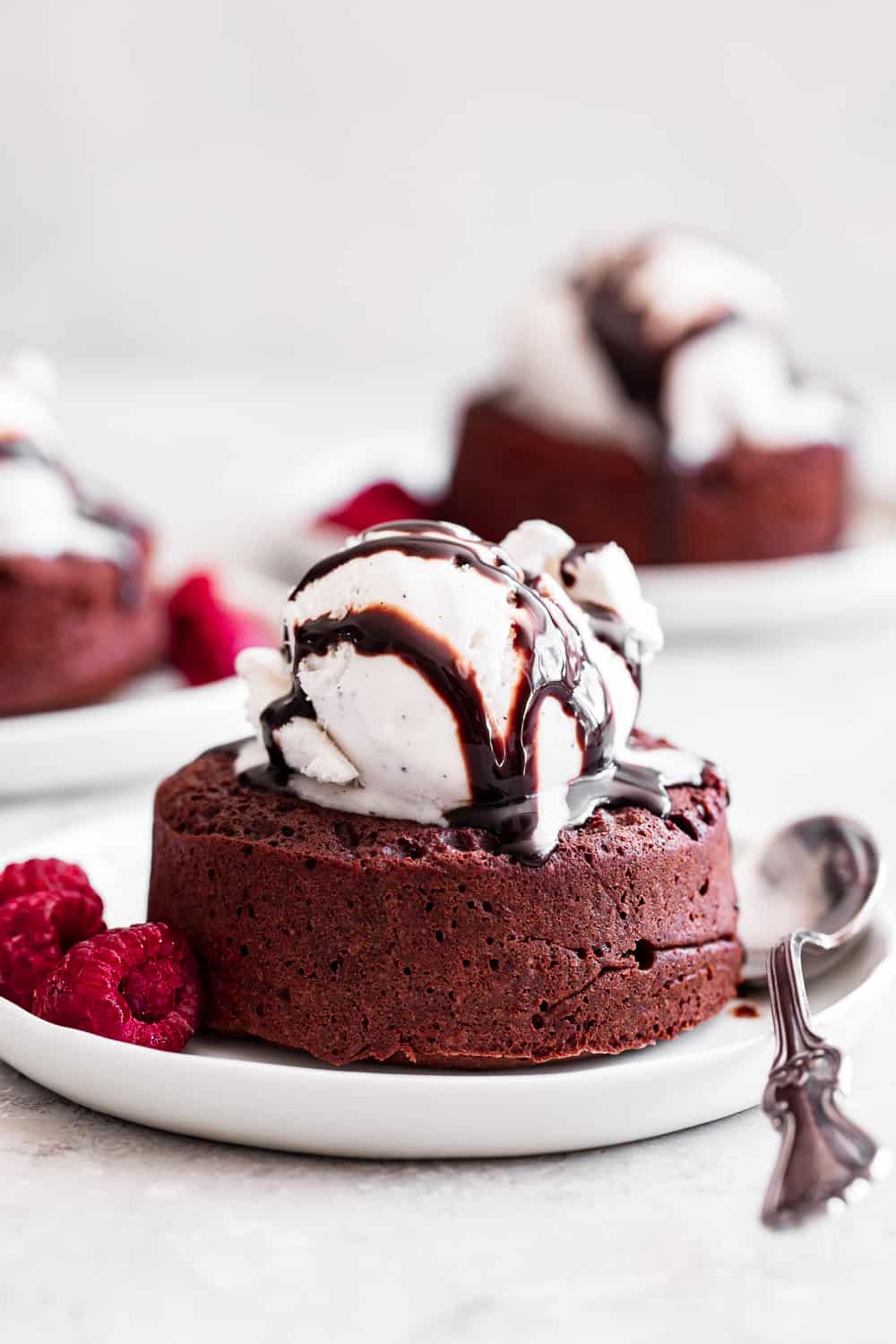 These simple chocolate molten lava cakes taste rich and decadent with a gooey chocolate filling.  They're made without flour or refined sugar but you would never guess!  It's the perfect easy treat to make for Valentine's Day or whenever you're craving something ultra chocolatey.  Gluten free, grain free, and paleo friendly. #paleo #glutenfree #chocolate #glutenfreebaking #healthybaking #cleaneating