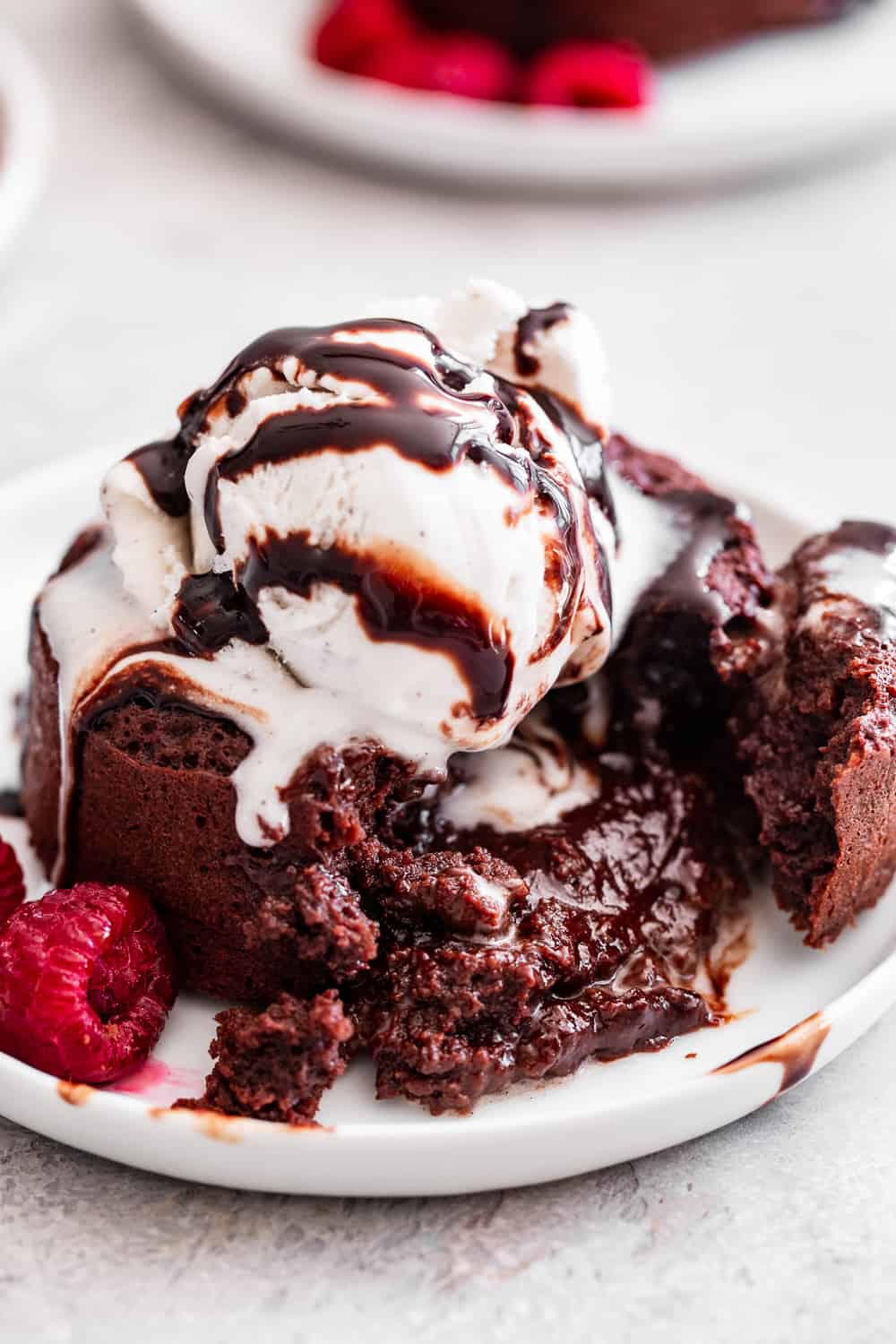 These simple chocolate molten lava cakes taste rich and decadent with a gooey chocolate filling.  They're made without flour or refined sugar but you would never guess!  It's the perfect easy treat to make for Valentine's Day or whenever you're craving something ultra chocolatey.  Gluten free, grain free, and paleo friendly. #paleo #glutenfree #chocolate #glutenfreebaking #healthybaking #cleaneating