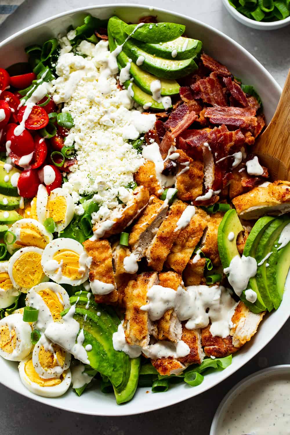 This crispy chicken cobb salad is my favorite one yet with flavorful crispy “breaded” chicken plus all the usual cobb salad goodies and a homemade garlic ranch dressing. It’s paleo, with a Whole30 option, low in carbs and family approved! #paleo #whole30 #cleaneating #keto #lowcarb