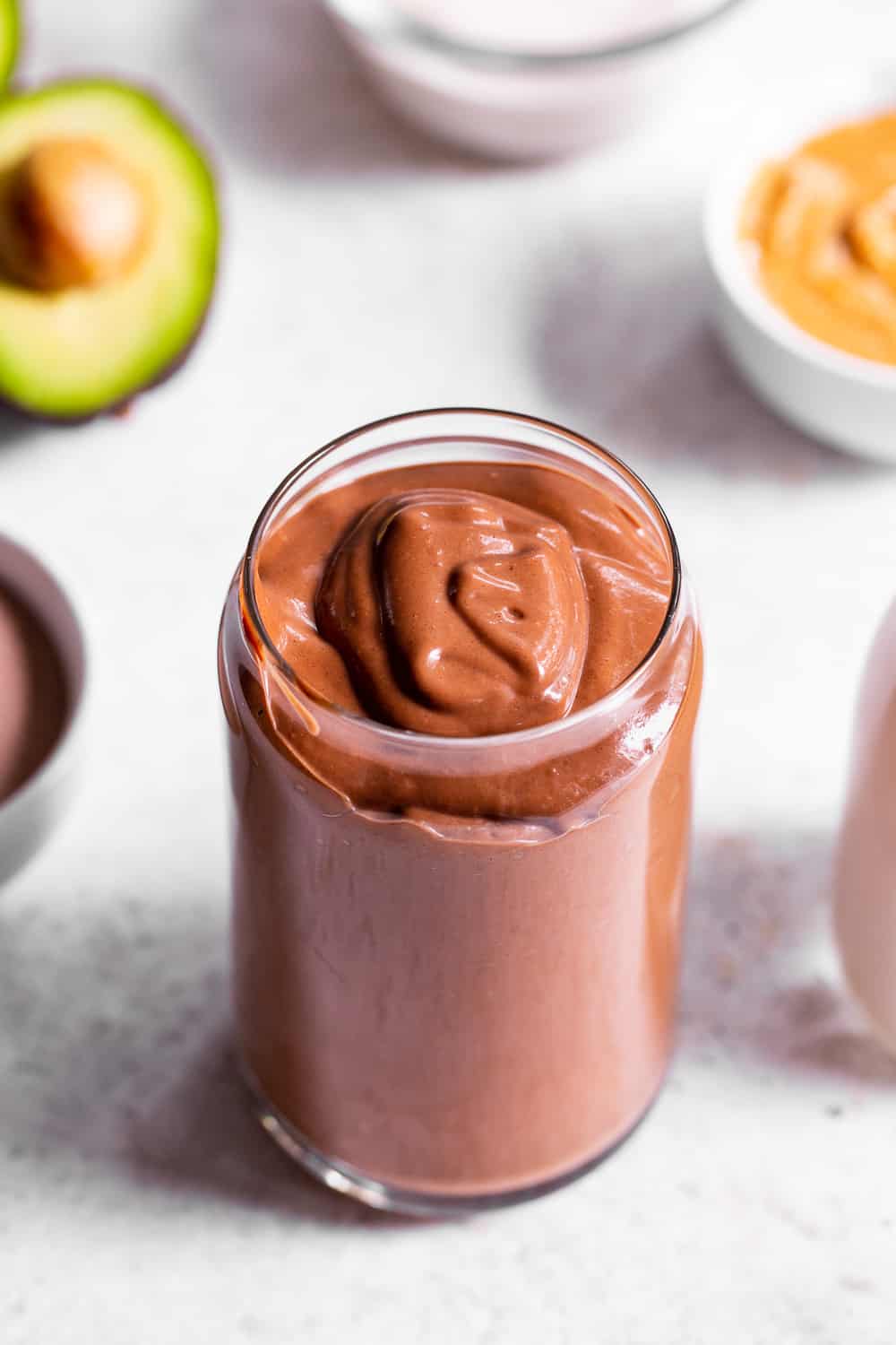 This creamy brownie batter chocolate smoothie is packed with good for you ingredients but tastes like dessert!  Have it for breakfast, a snack, or healthy dessert.  It's paleo friendly, dairy free, vegan and free of refined sugar.  Add your favorite chocolate protein powder for an extra chocolate kick! #paleo #vegan #cleaneating