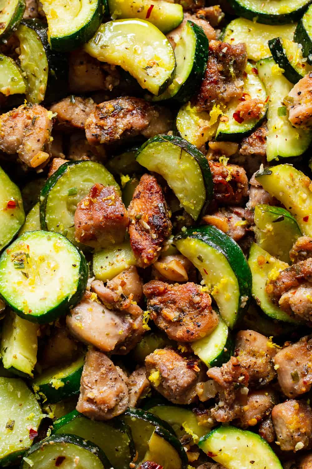 This Lemon Garlic Chicken Zucchini is packed with flavor, fast and easy for weeknights! Bite sized chicken thighs are perfectly seasoned and sautéed with zucchini and garlic then tossed with lemon juice and zest. Great alone or served over grain free noodles or cauliflower rice to keep it paleo, keto and Whole30. #paleo #whole30 #keto #cleaneating 