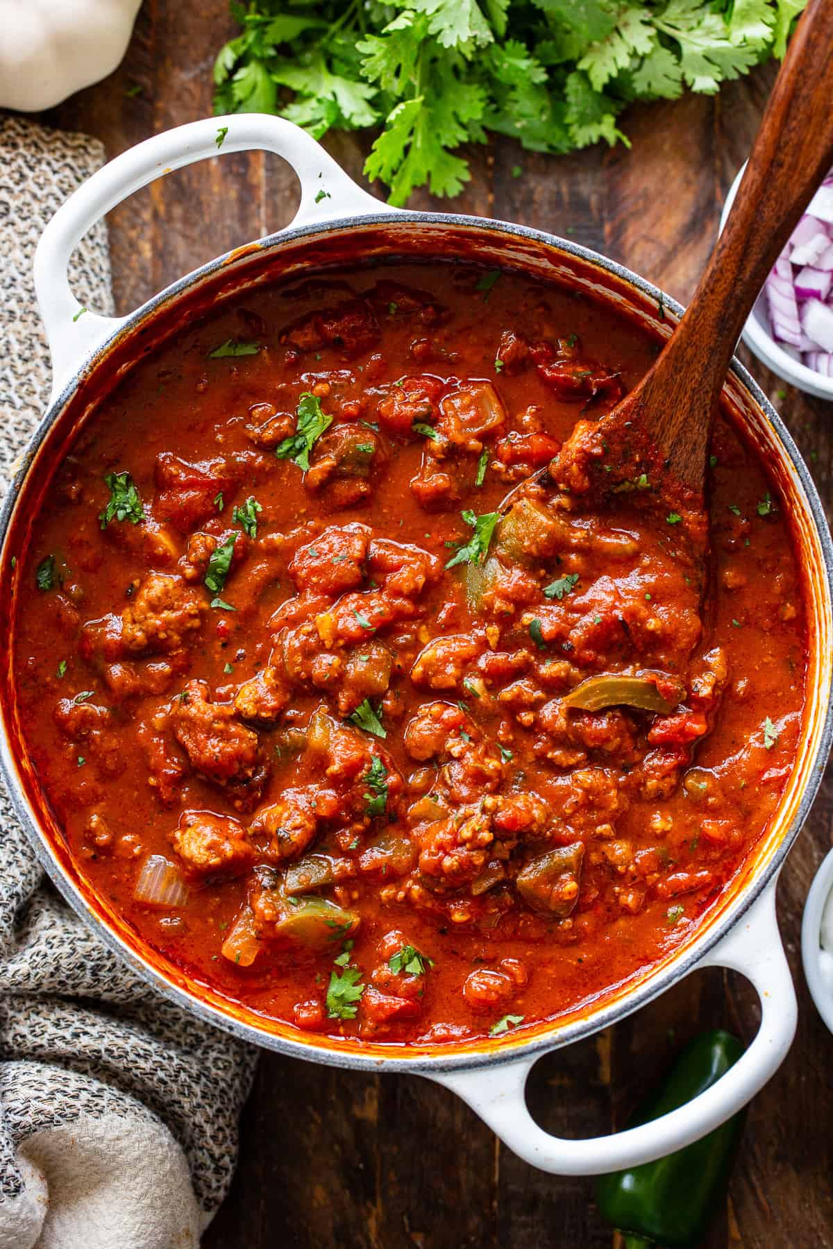 Thick paleo pumpkin chili with ground beef and vegetables in a white Dutch oven
