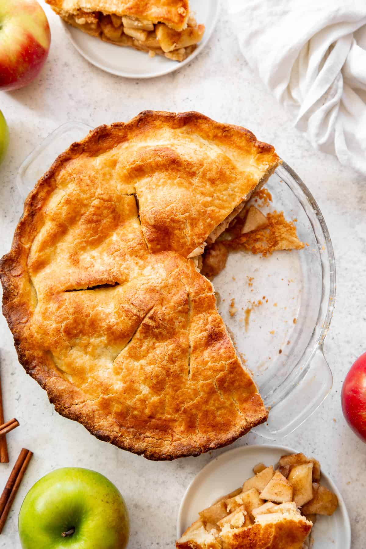 Overhead shot of paleo apple pie with two slices removed and on plates