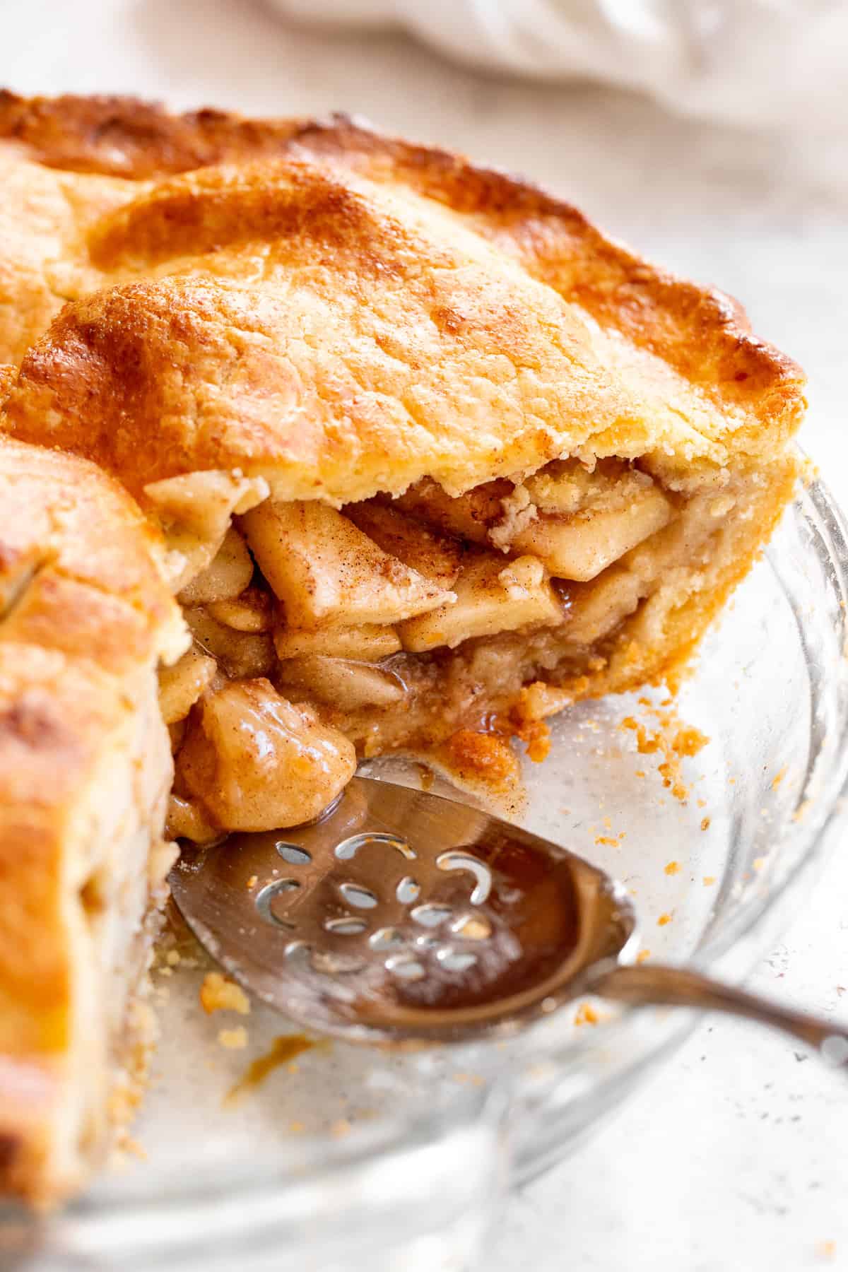 pie dish showing inside of paleo apple pie with serving utensil