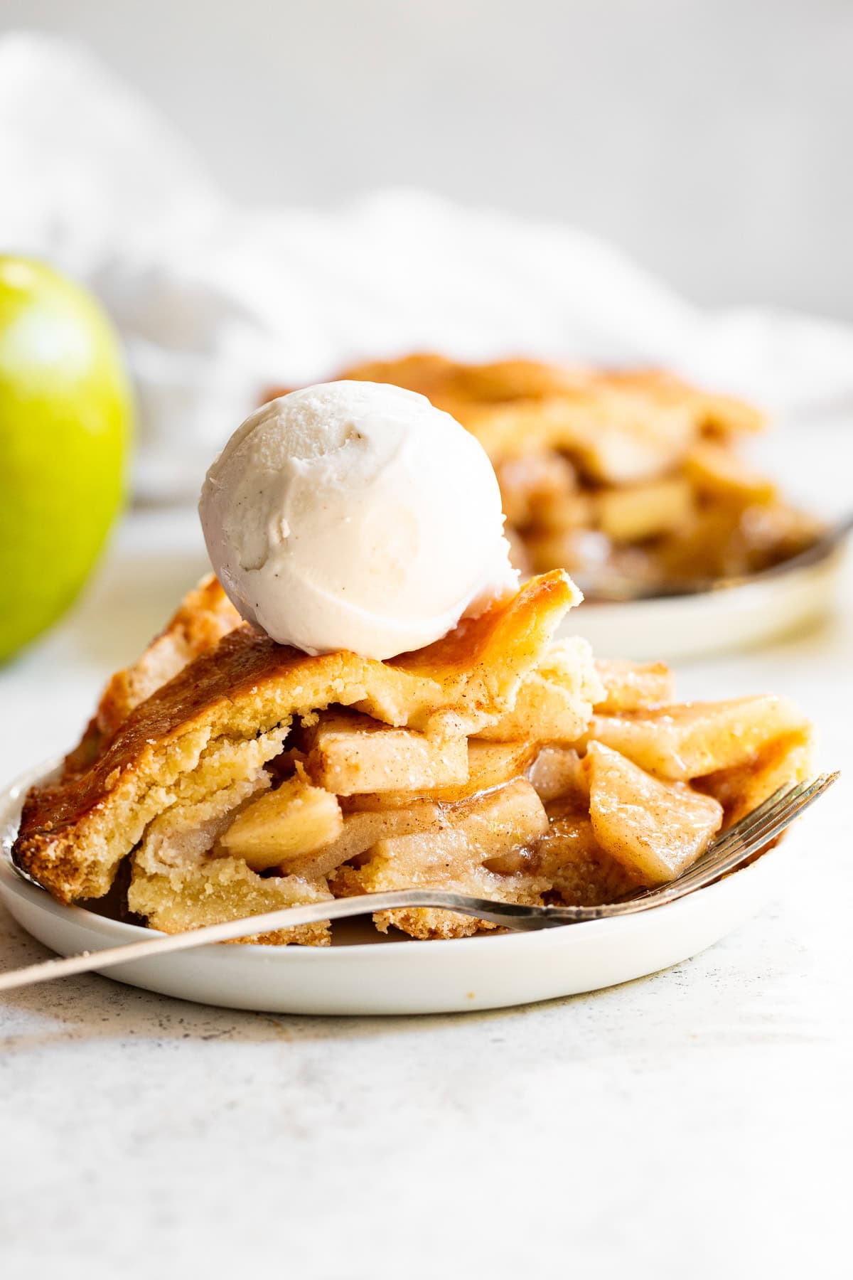 slice of paleo apple pie with a scoop of vanilla ice cream