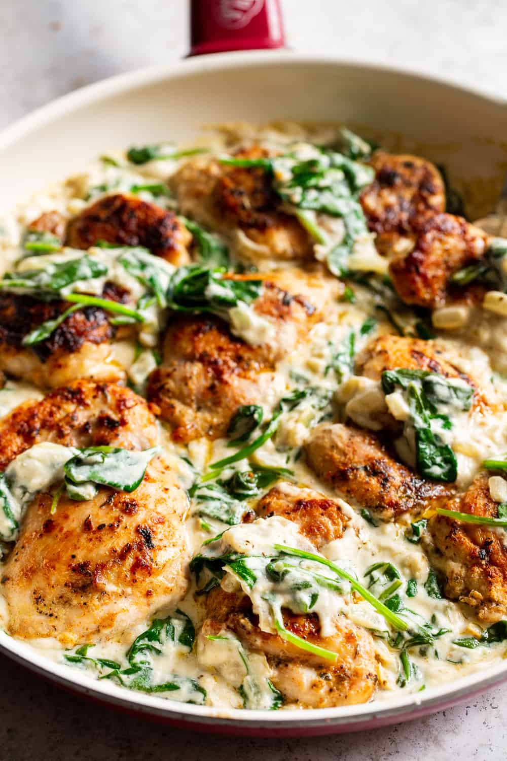 This one pot creamed spinach chicken is paleo, Whole30 friendly and dairy free but you’d never guess! Juicy seasoned chicken is cooked in one skillet with a creamy, “cheesy” sauce and spinach that’s easy and great for weeknights! The leftovers are perfect for lunch the next day too. #paleo #whole30 #keto #cleaneating 