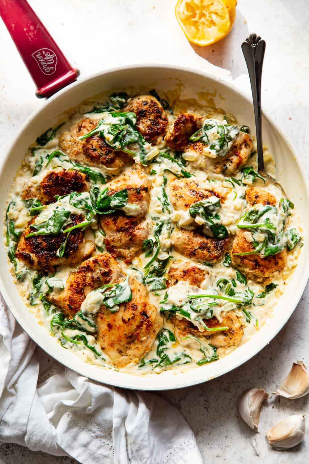 This one pot creamed spinach chicken is paleo, Whole30 friendly and dairy free but you’d never guess! Juicy seasoned chicken is cooked in one skillet with a creamy, “cheesy” sauce and spinach that’s easy and great for weeknights! The leftovers are perfect for lunch the next day too. #paleo #whole30 #keto #cleaneating 
