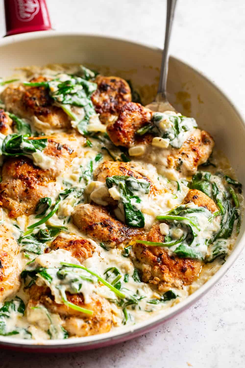 This one pot creamed spinach chicken is paleo, Whole30 friendly and dairy free but you’d never guess! Juicy seasoned chicken is cooked in one skillet with a creamy, “cheesy” sauce and spinach that’s easy and great for weeknights! The leftovers are perfect for lunch the next day too. #paleo #whole30 #keto #cleaneating 