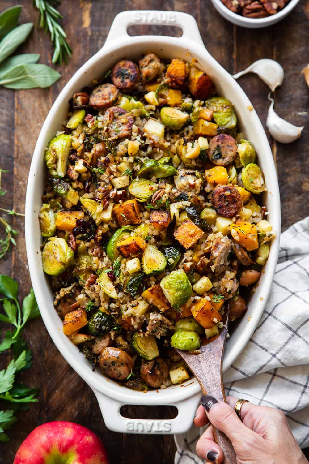 This savory and sweet harvest casserole is packed with veggies, protein, fresh herbs and all the best fall flavors! Serve it as a holiday side dish or a special seasonal meal. The leftovers are delicious for any meal! Paleo friendly, dairy free, Whole30. #paleo #whole30 #cleaneating 