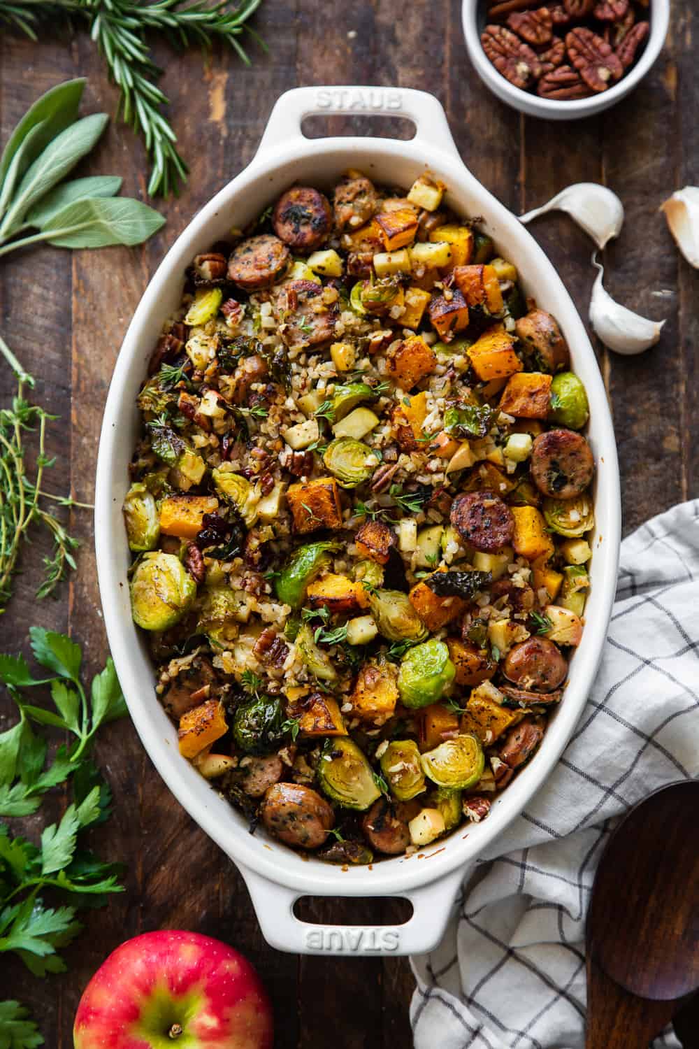 This savory and sweet harvest casserole is packed with veggies, protein, fresh herbs and all the best fall flavors! Serve it as a holiday side dish or a special seasonal meal. The leftovers are delicious for any meal! Paleo friendly, dairy free, Whole30. #paleo #whole30 #cleaneating 