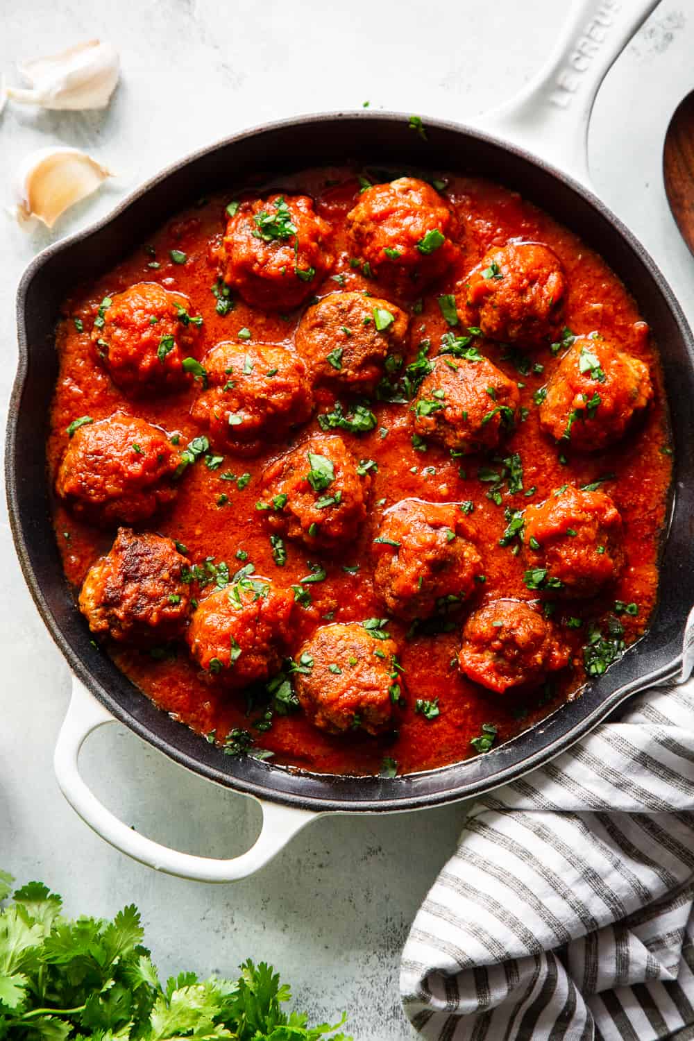 These quick skillet meatballs have been a favorite weeknight meal for my family for years!  You can prep and cook these meatballs in just 25 minutes and they never get complaints.  Serve over veggie noodles or spaghetti squash, with gluten free or grain free pasta, over sautéed greens or with a big green salad.  They're paleo, Whole30 and keto friendly. #paleo #keto #meatballs #lowcarb #cleaneating #whole30