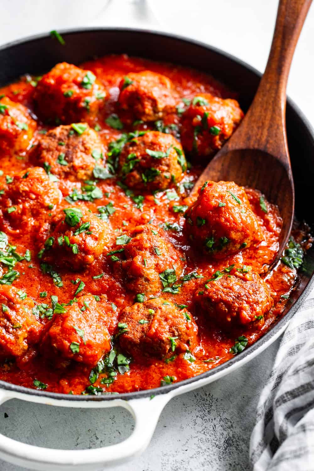 These quick skillet meatballs have been a favorite weeknight meal for my family for years!  You can prep and cook these meatballs in just 25 minutes and they never get complaints.  Serve over veggie noodles or spaghetti squash, with gluten free or grain free pasta, over sautéed greens or with a big green salad.  They're paleo, Whole30 and keto friendly. #paleo #keto #meatballs #lowcarb #cleaneating #whole30