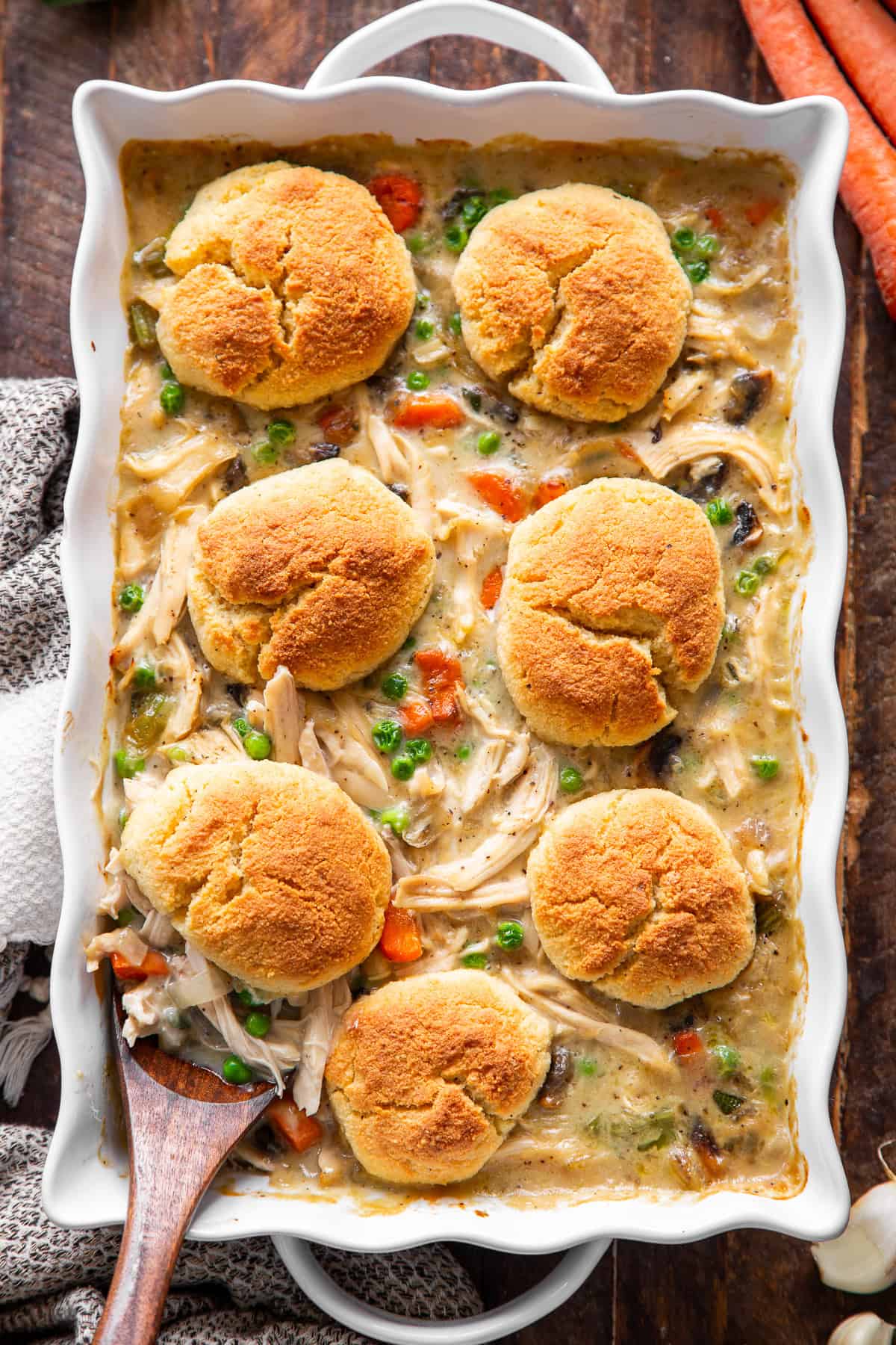 chicken pot pie casserole with golden biscuits, chicken and vegetables.