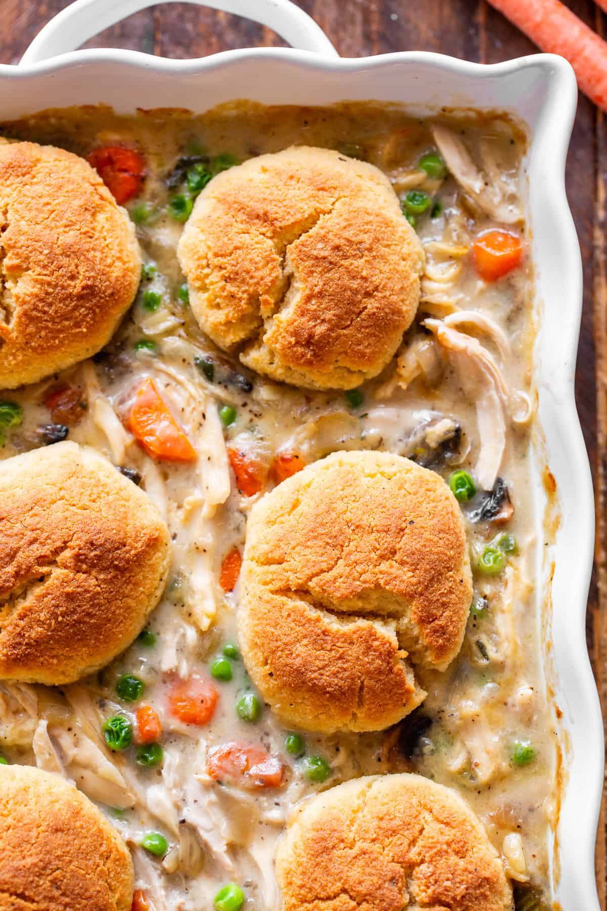 chicken pot pie casserole with golden biscuits and creamy chicken vegetable filling.