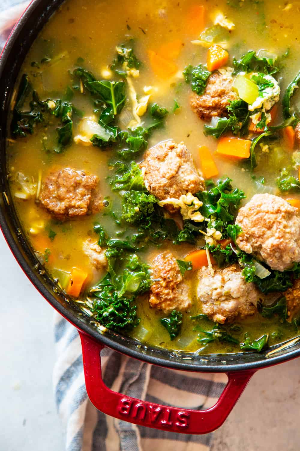 This Paleo Italian Wedding Soup is the perfect cozy comfort food! It’s easy to make, packed with the tastiest Italian sausage meatballs and plenty of veggies. It’s grain free, Whole30 friendly and keto. #paleo #whole30 #keto #cleaneating #soup