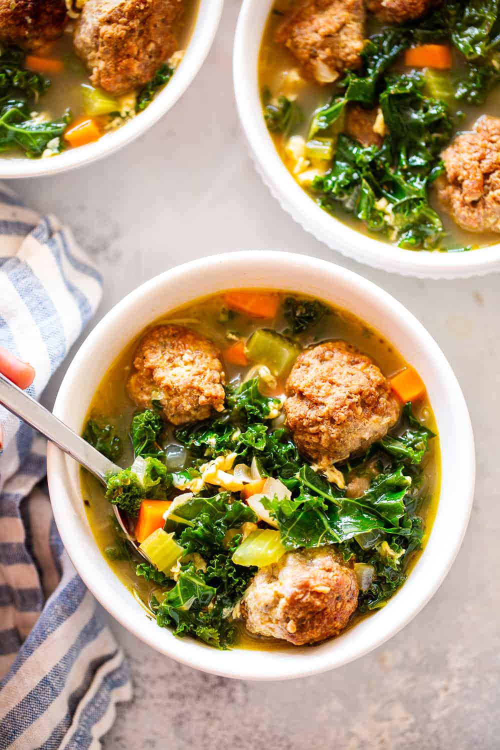 This Paleo Italian Wedding Soup is the perfect cozy comfort food! It’s easy to make, packed with the tastiest Italian sausage meatballs and plenty of veggies. It’s grain free, Whole30 friendly and keto. #paleo #whole30 #keto #cleaneating #soup