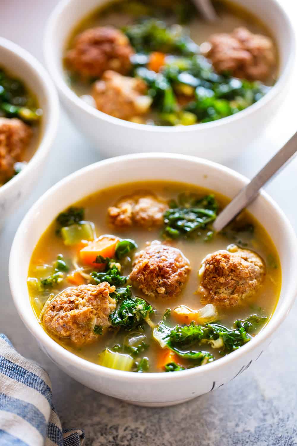 This Paleo Italian Wedding Soup is the perfect cozy comfort food! It’s easy to make, packed with the tastiest Italian sausage meatballs and plenty of veggies. It’s grain free, Whole30 friendly and keto. #paleo #whole30 #keto #cleaneating #soup