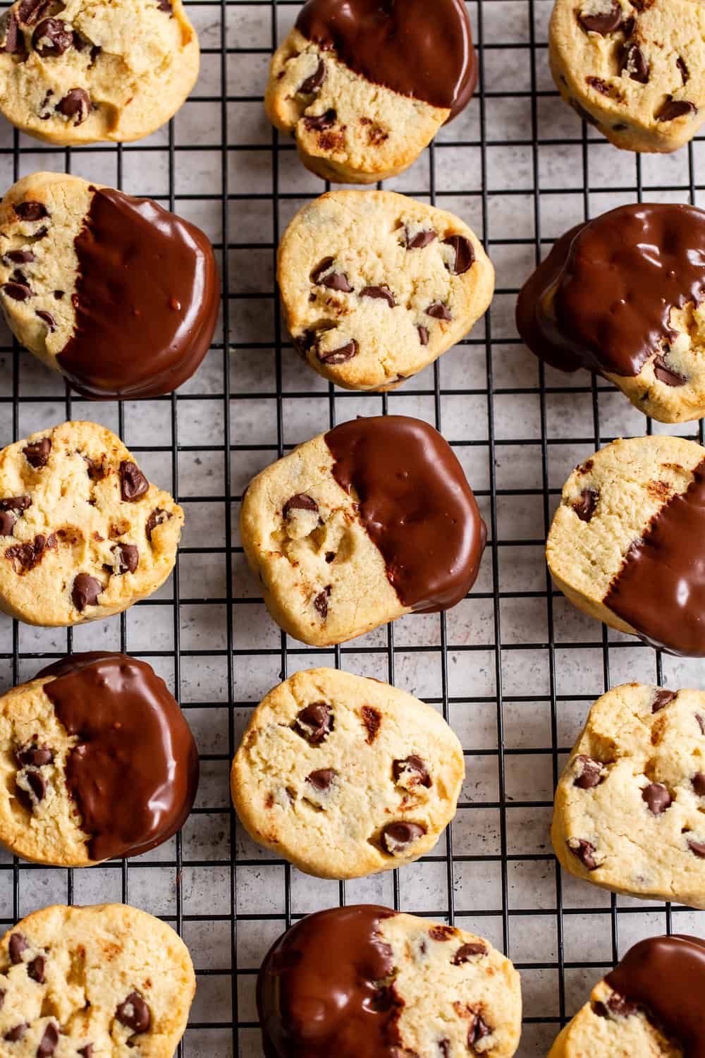 These paleo slice and bake cookies are surprisingly easy to make, studded with chocolate chips and dipped in chocolate! They’re grain free and refined sugar free with dairy free options. Perfect for holiday baking or anytime! #paleo #paleobaking #glutenfree #glutenfreebaking #cleaneating