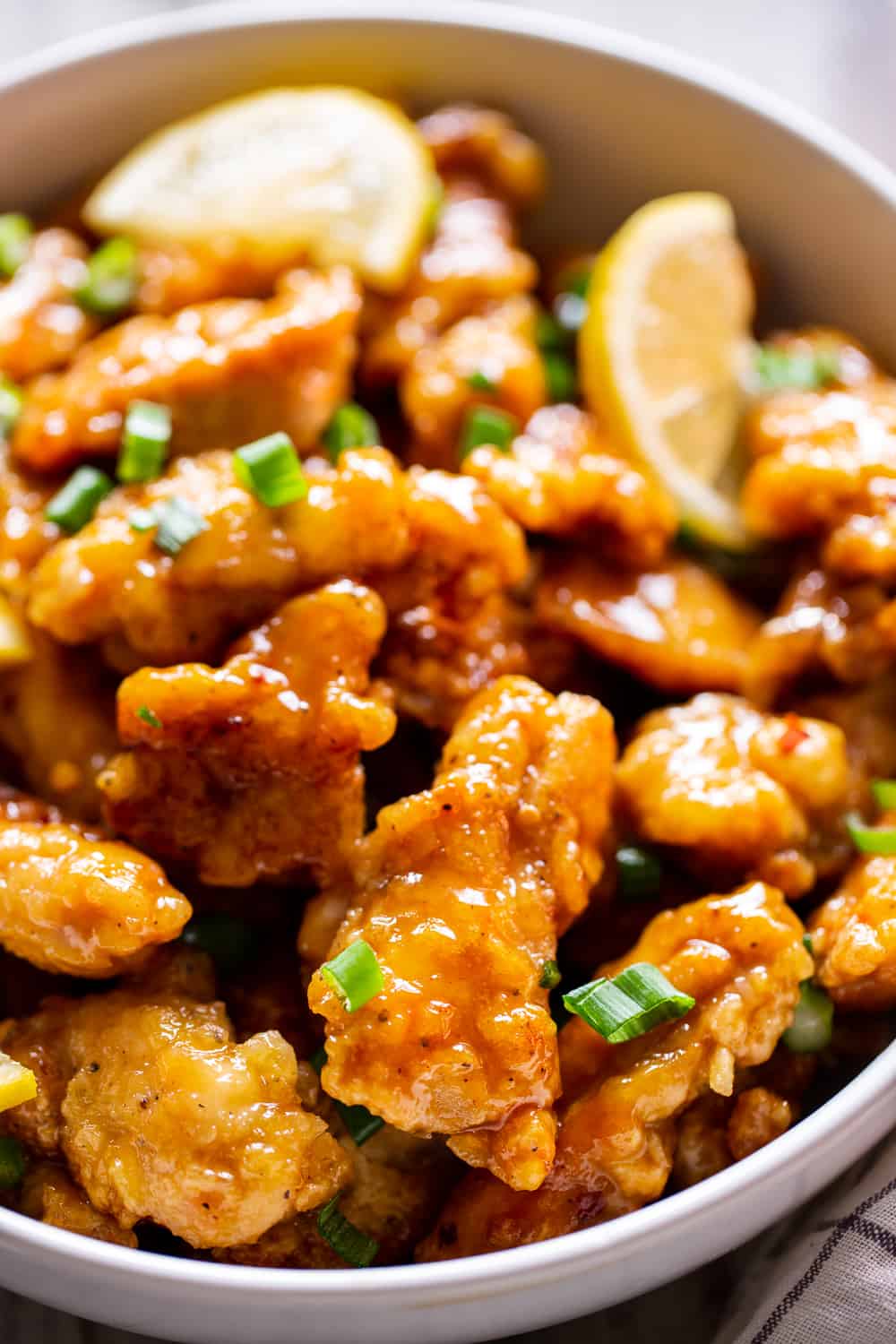 This flavor packed Paleo Chinese Lemon Chicken is a healthier homemade version of a takeout favorite! It’s easy to make and contains no refined sugar, family approved and seriously tasty with a Whole30 option.  Keep it Paleo and Whole30 by serving over sautéed cauliflower rice or with your favorite stir fried veggies. #paleo #paleorecipes #cleaneating 
