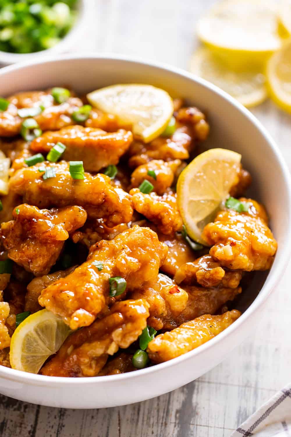 This flavor packed Paleo Chinese Lemon Chicken is a healthier homemade version of a takeout favorite! It’s easy to make and contains no refined sugar, family approved and seriously tasty with a Whole30 option.  Keep it Paleo and Whole30 by serving over sautéed cauliflower rice or with your favorite stir fried veggies. #paleo #paleorecipes #cleaneating 