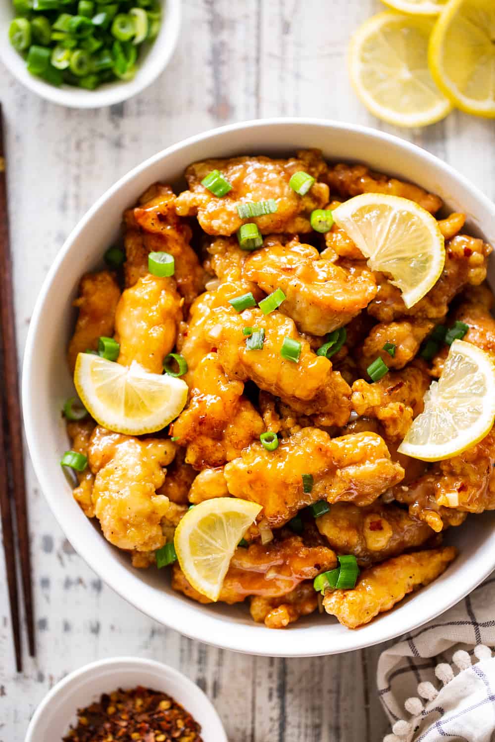 This flavor packed Paleo Chinese Lemon Chicken is a healthier homemade version of a takeout favorite! It’s easy to make and contains no refined sugar, family approved and seriously tasty with a Whole30 option.  Keep it Paleo and Whole30 by serving over sautéed cauliflower rice or with your favorite stir fried veggies. #paleo #paleorecipes #cleaneating 