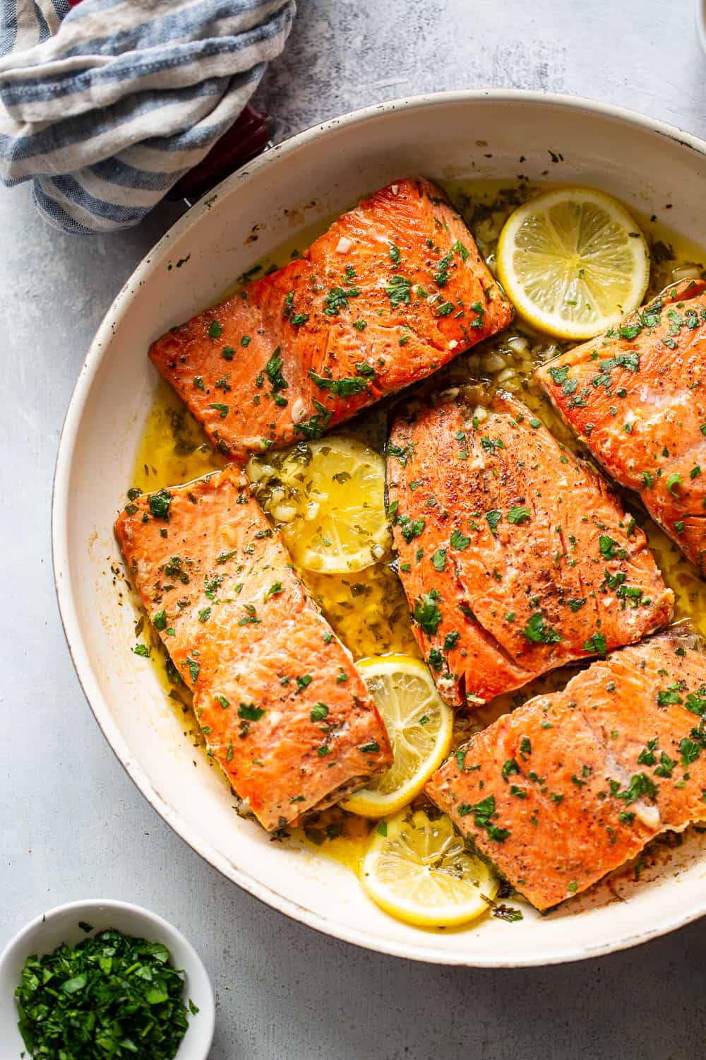 This simple and classic garlic lemon butter salmon recipe is packed with flavor and goes with all your favorite side dishes. Keep it low in carbs with cauliflower rice or serve with crispy roasted potatoes for a delicious, Whole30 friendly option. You’re going to want this one in your dinner rotation ASAP! #paleo #whole30 #keto #cleaneating