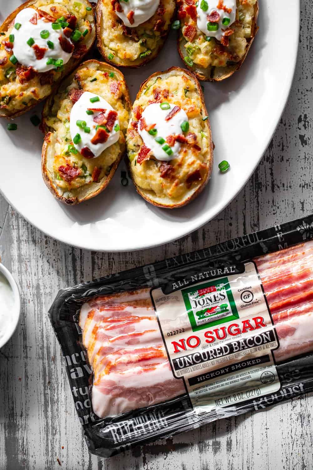 It’s all the delicious comfort of classic twice baked potatoes, made Whole30 friendly! Potato skins are loaded with a creamy mixture of mashed potatoes, bacon, scallions and even a dairy free sour cream. Great as a side dish or full meal, perfect to prep ahead of time too and easy to reheat! #paleo #whole30 #cleaneating 