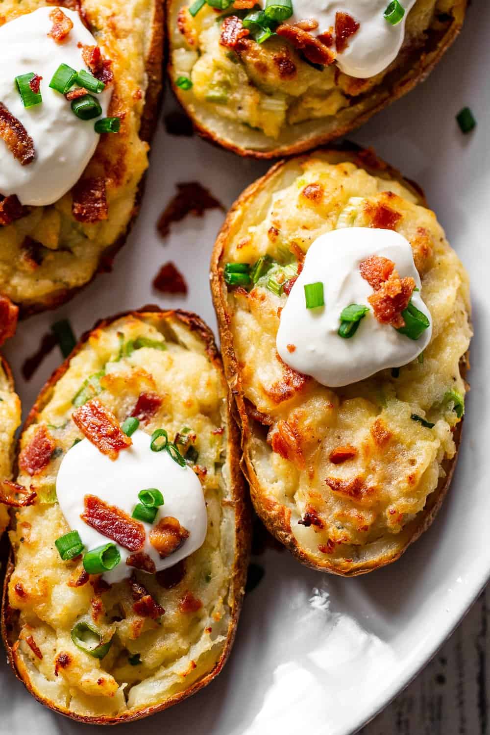 It’s all the delicious comfort of classic twice baked potatoes, made Whole30 friendly! Potato skins are loaded with a creamy mixture of mashed potatoes, bacon, scallions and even a dairy free sour cream. Great as a side dish or full meal, perfect to prep ahead of time too and easy to reheat! #paleo #whole30 #cleaneating 