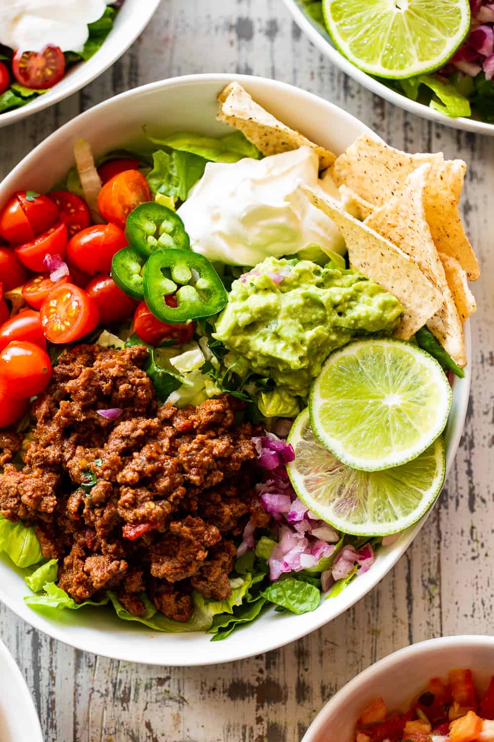 This easy, flavor packed paleo taco salad is ready in 20 minutes from start to finish and great for an easy weeknight dinner! Whole30 and keto options. #paleo #whole30 #keto #cleaneating 