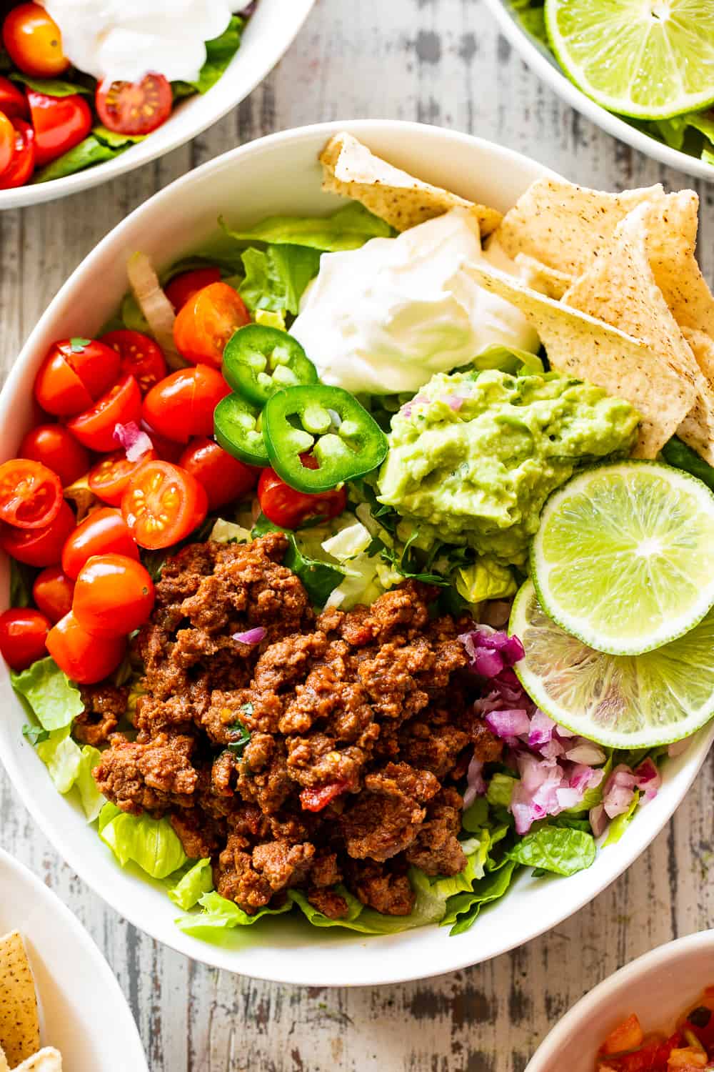 This easy, flavor packed paleo taco salad is ready in 20 minutes from start to finish and great for an easy weeknight dinner! Whole30 and keto options. #paleo #whole30 #keto #cleaneating 