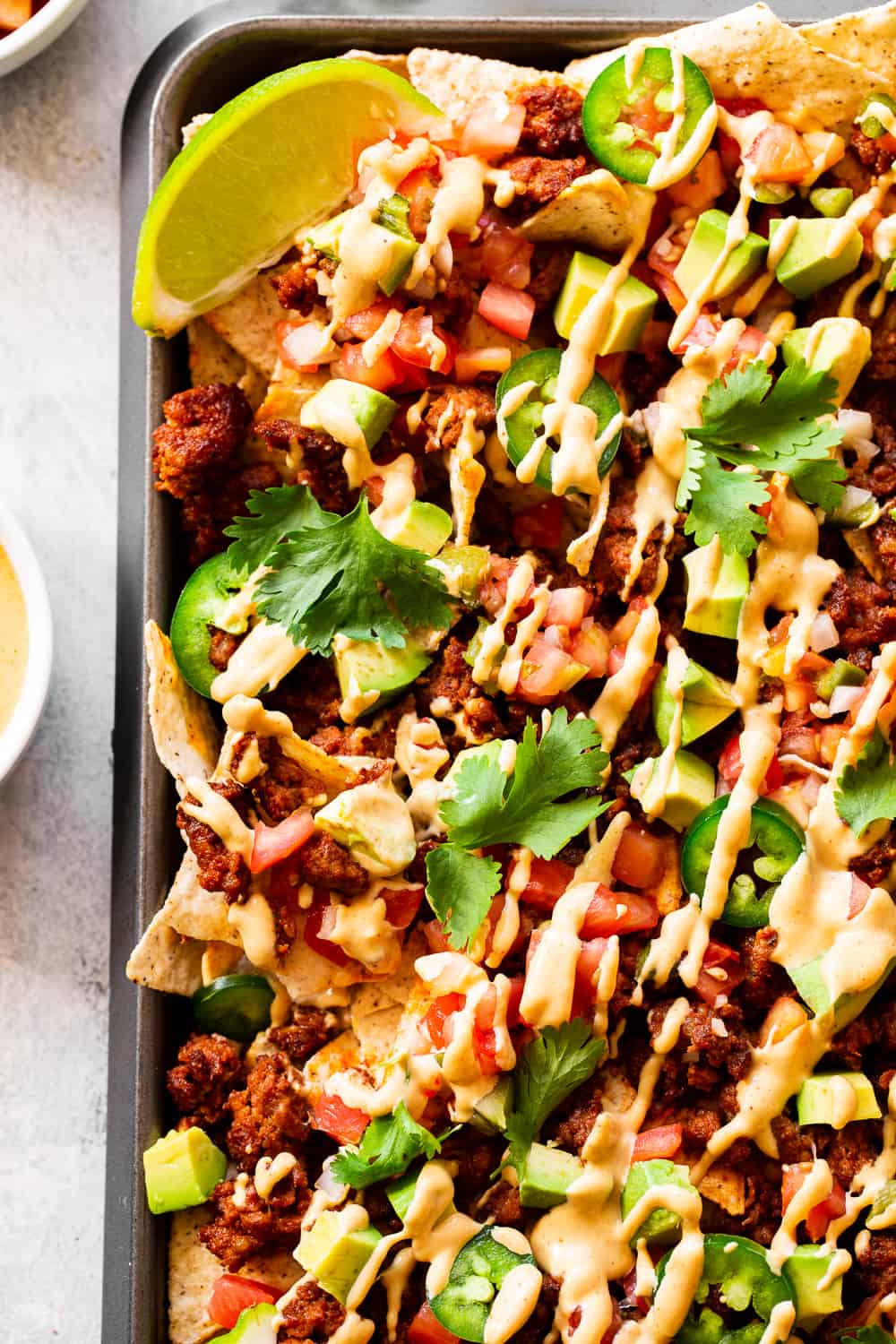 These quick and easy grain free, dairy free paleo nachos don’t sacrifice anything - they’re loaded with chorizo, pico de gallo, avocados and the easiest nacho “cheese” sauce! Great as an appetizer or snack but works well for dinner too! #paleo #cleaneating #dairyfree