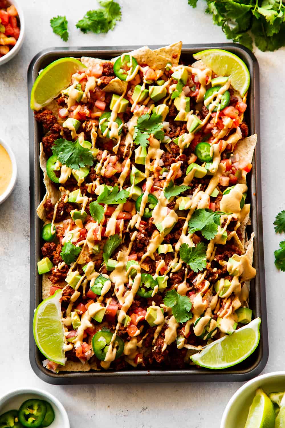 These quick and easy grain free, dairy free paleo nachos don’t sacrifice anything - they’re loaded with chorizo, pico de gallo, avocados and the easiest nacho “cheese” sauce! Great as an appetizer or snack but works well for dinner too! #paleo #cleaneating #dairyfree