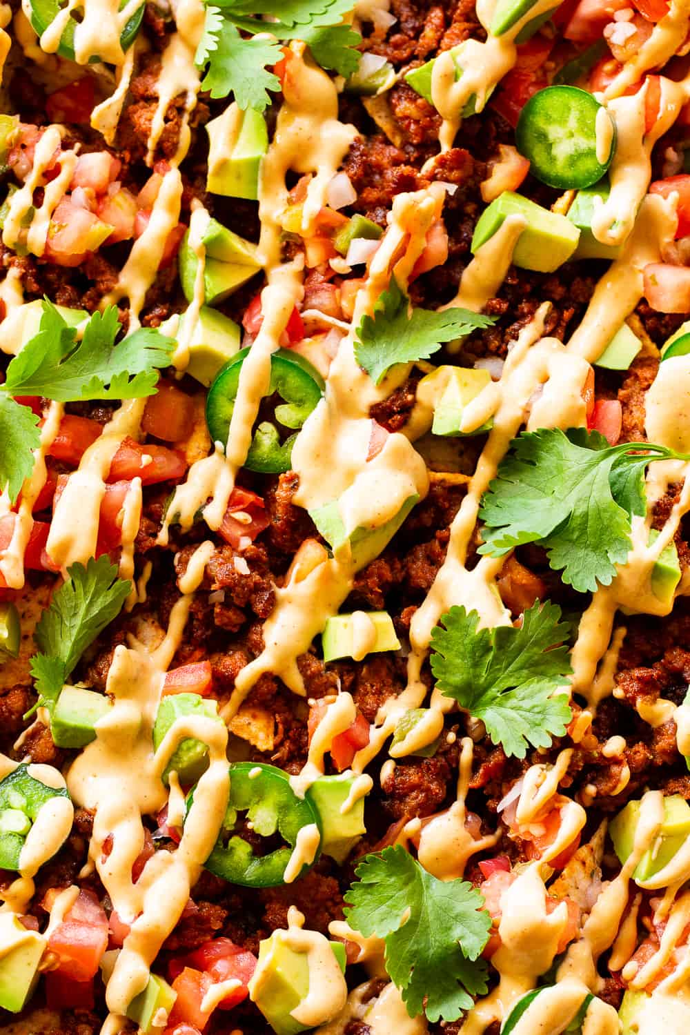 These quick and easy grain free, dairy free paleo nachos don’t sacrifice anything - they’re loaded with chorizo, pico de gallo, avocados and the easiest nacho “cheese” sauce! Great as an appetizer or snack but works well for dinner too! #paleo #cleaneating #dairyfree
