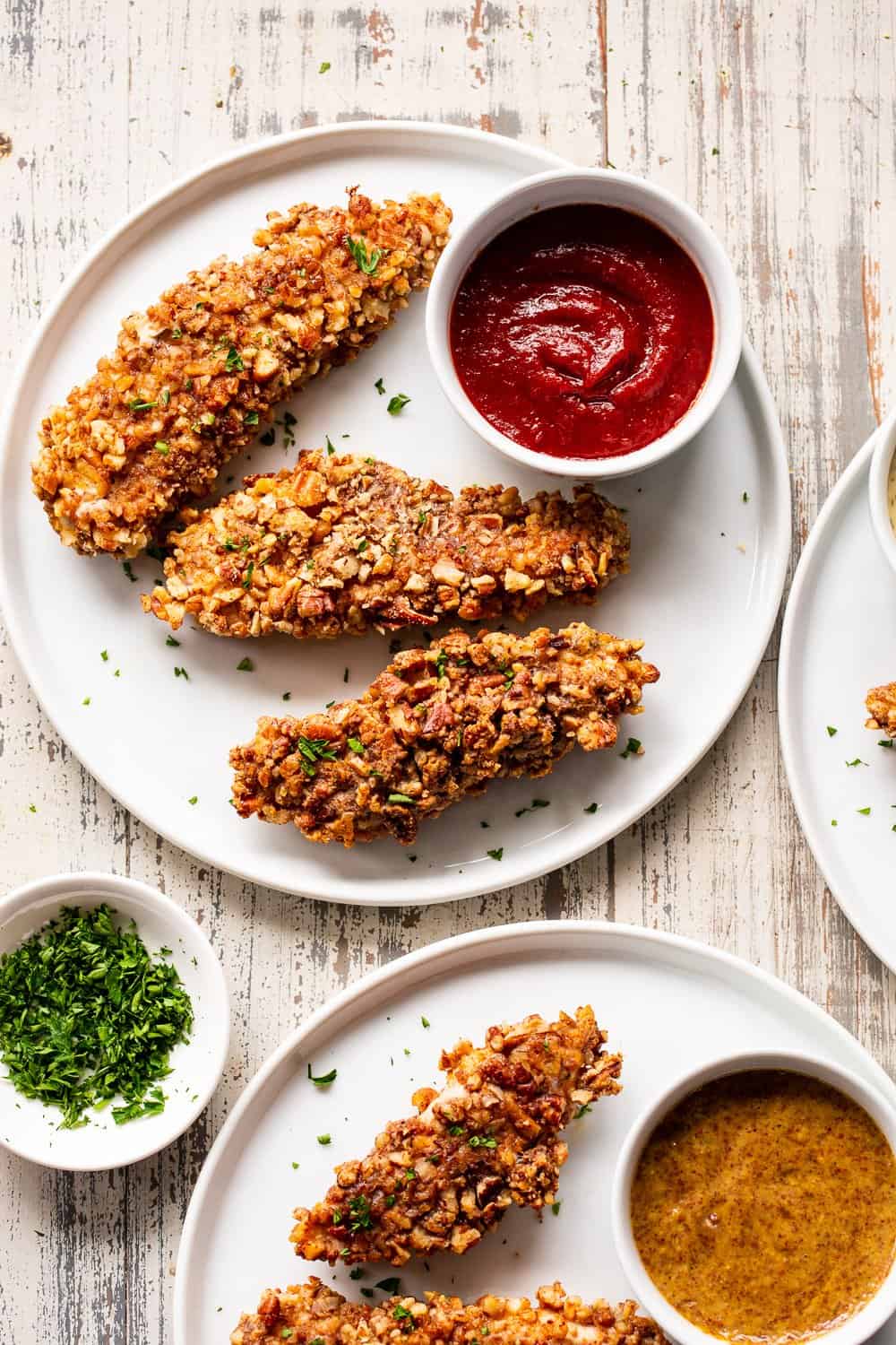 These pecan crusted chicken tenders are easy to throw together, baked in the oven and so tasty! Amazing with all your favorite dips and totally kid friendly, they're also paleo, Whole30 and keto friendly. #paleo #keto #cleaneating #chicken #whole30