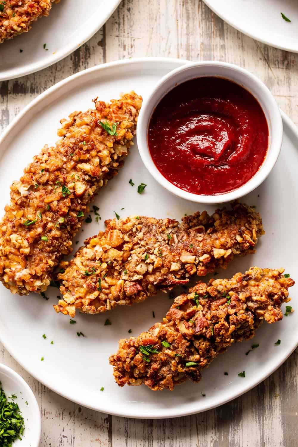 These pecan crusted chicken tenders are easy to throw together, baked in the oven and so tasty! Amazing with all your favorite dips and totally kid friendly, they're also paleo, Whole30 and keto friendly. #paleo #keto #cleaneating #chicken #whole30