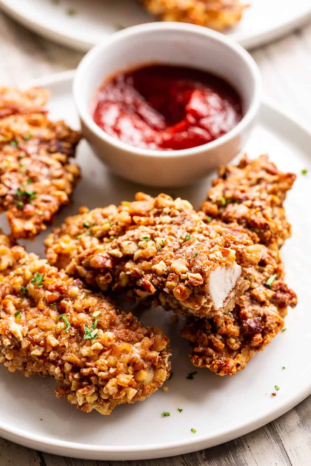 These pecan crusted chicken tenders are easy to throw together, baked in the oven and so tasty! Amazing with all your favorite dips and totally kid friendly, they're also paleo, Whole30 and keto friendly. #paleo #keto #cleaneating #chicken #whole30