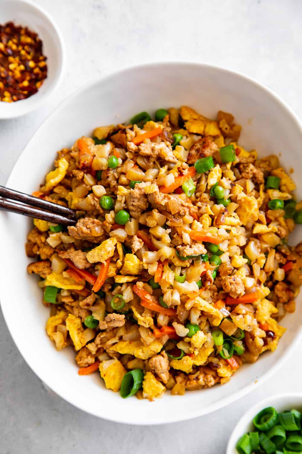 This Cauliflower Pork Fried Rice is loaded with flavor, protein, veggies and healthy fats and makes a fast weeknight meal that everyone will love.  Paleo, Whole30, low carb and kid approved! #paleo #whole30 #keto #cleaneating