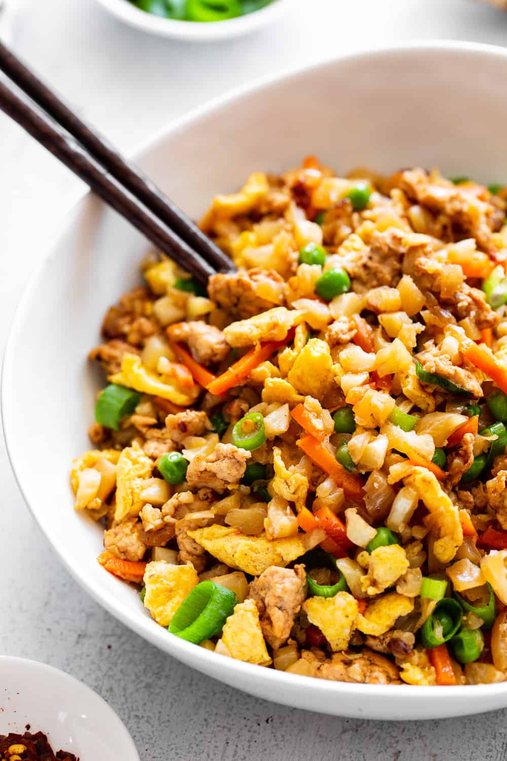 This Cauliflower Pork Fried Rice is loaded with flavor, protein, veggies and healthy fats and makes a fast weeknight meal that everyone will love.  Paleo, Whole30, low carb and kid approved! #paleo #whole30 #keto #cleaneating