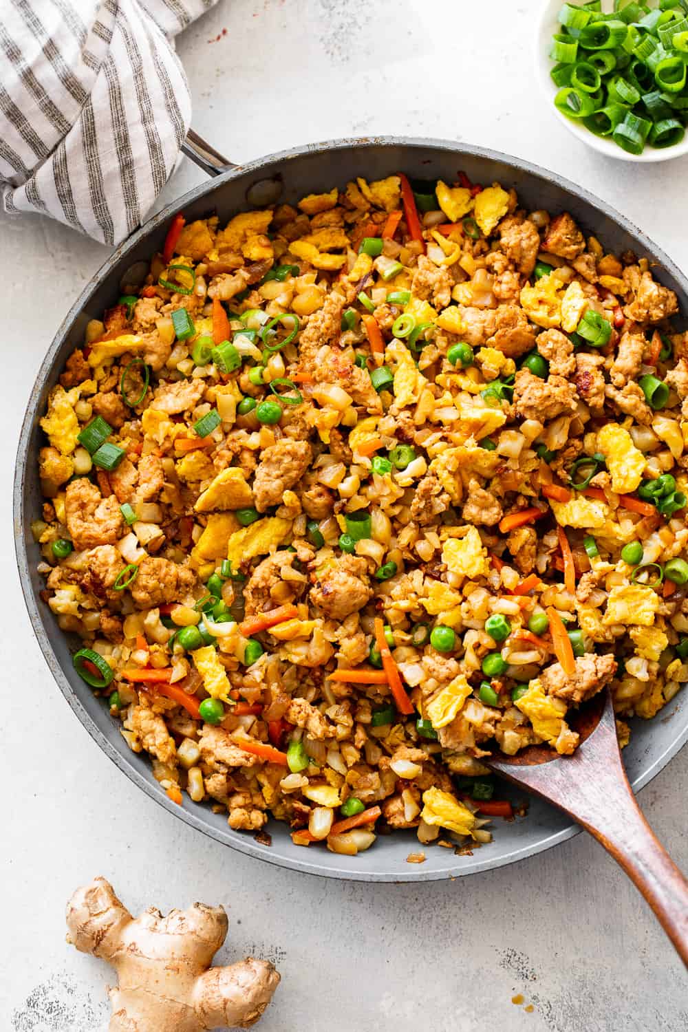 This Cauliflower Pork Fried Rice is loaded with flavor, protein, veggies and healthy fats and makes a fast weeknight meal that everyone will love.  Paleo, Whole30, low carb and kid approved! #paleo #whole30 #keto #cleaneating