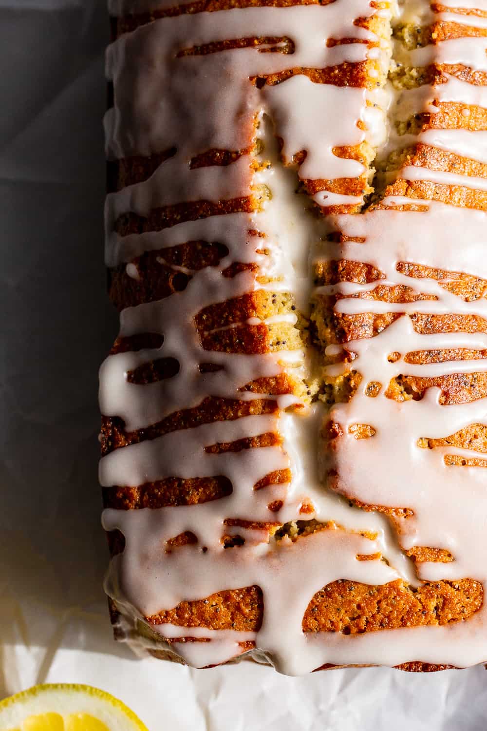 This Paleo Lemon Poppy Seed Bread is tender, moist and loaded with lemon flavor with just the right amount of sweetness.  It's drizzled with a sweet glaze for the perfect touch.  Great for brunches, dessert and snacks, this quick bread is gluten free, grain free, dairy free and refined sugar free. #paleo #glutenfree #grainfree 