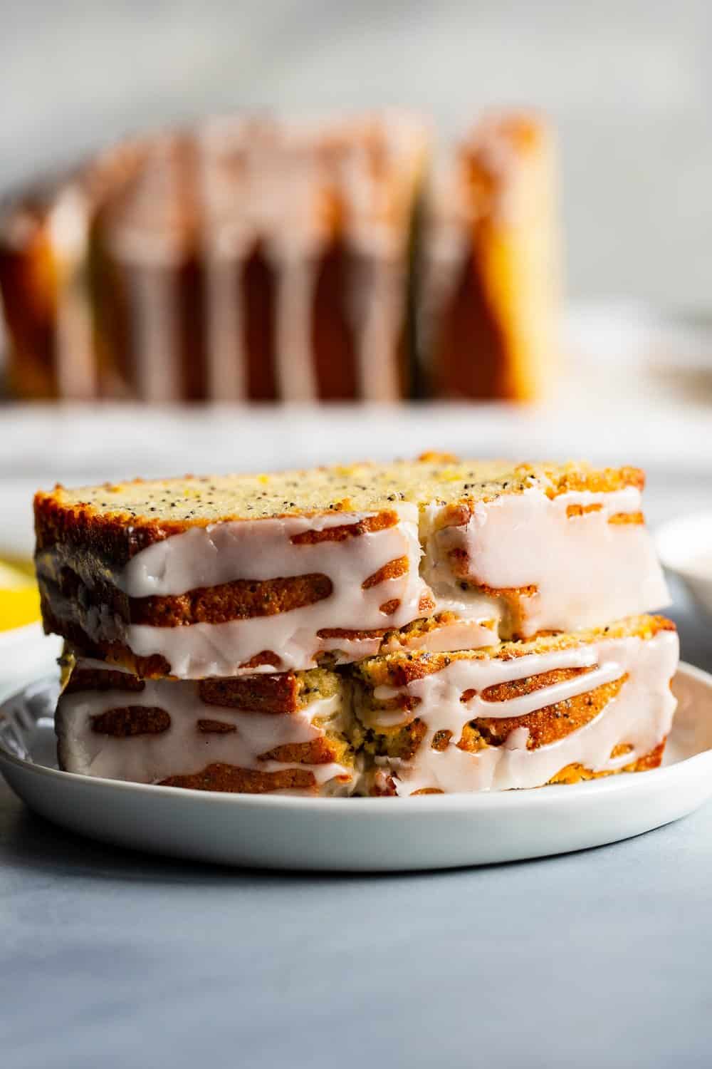 This Paleo Lemon Poppy Seed Bread is tender, moist and loaded with lemon flavor with just the right amount of sweetness.  It's drizzled with a sweet glaze for the perfect touch.  Great for brunches, dessert and snacks, this quick bread is gluten free, grain free, dairy free and refined sugar free. #paleo #glutenfree #grainfree 