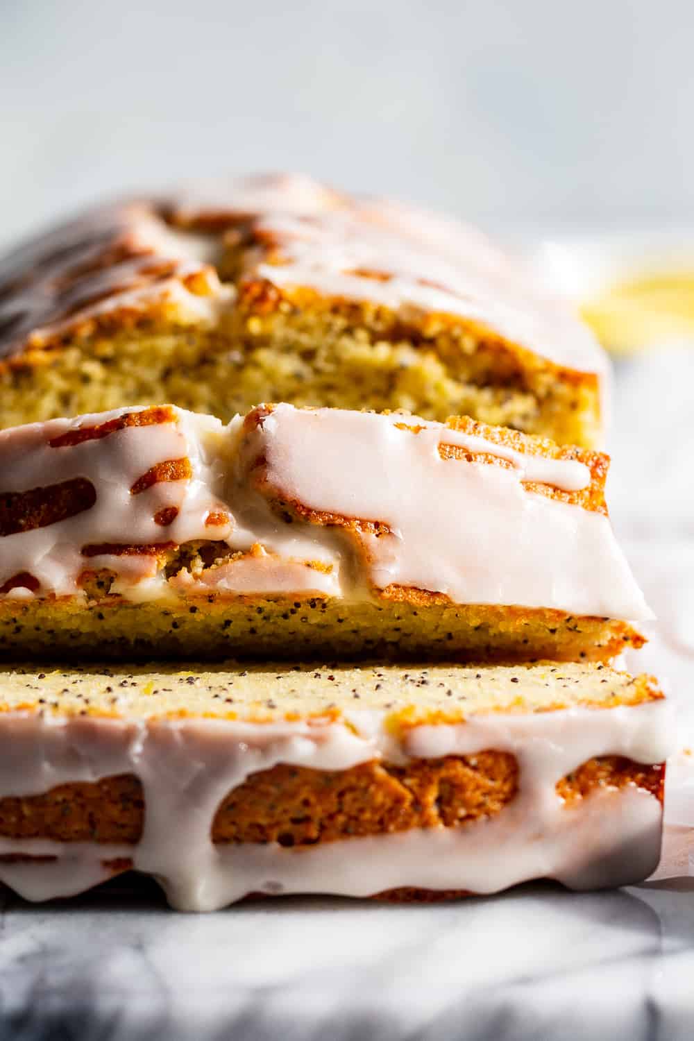 This Paleo Lemon Poppy Seed Bread is tender, moist and loaded with lemon flavor with just the right amount of sweetness.  It's drizzled with a sweet glaze for the perfect touch.  Great for brunches, dessert and snacks, this quick bread is gluten free, grain free, dairy free and refined sugar free. #paleo #glutenfree #grainfree 