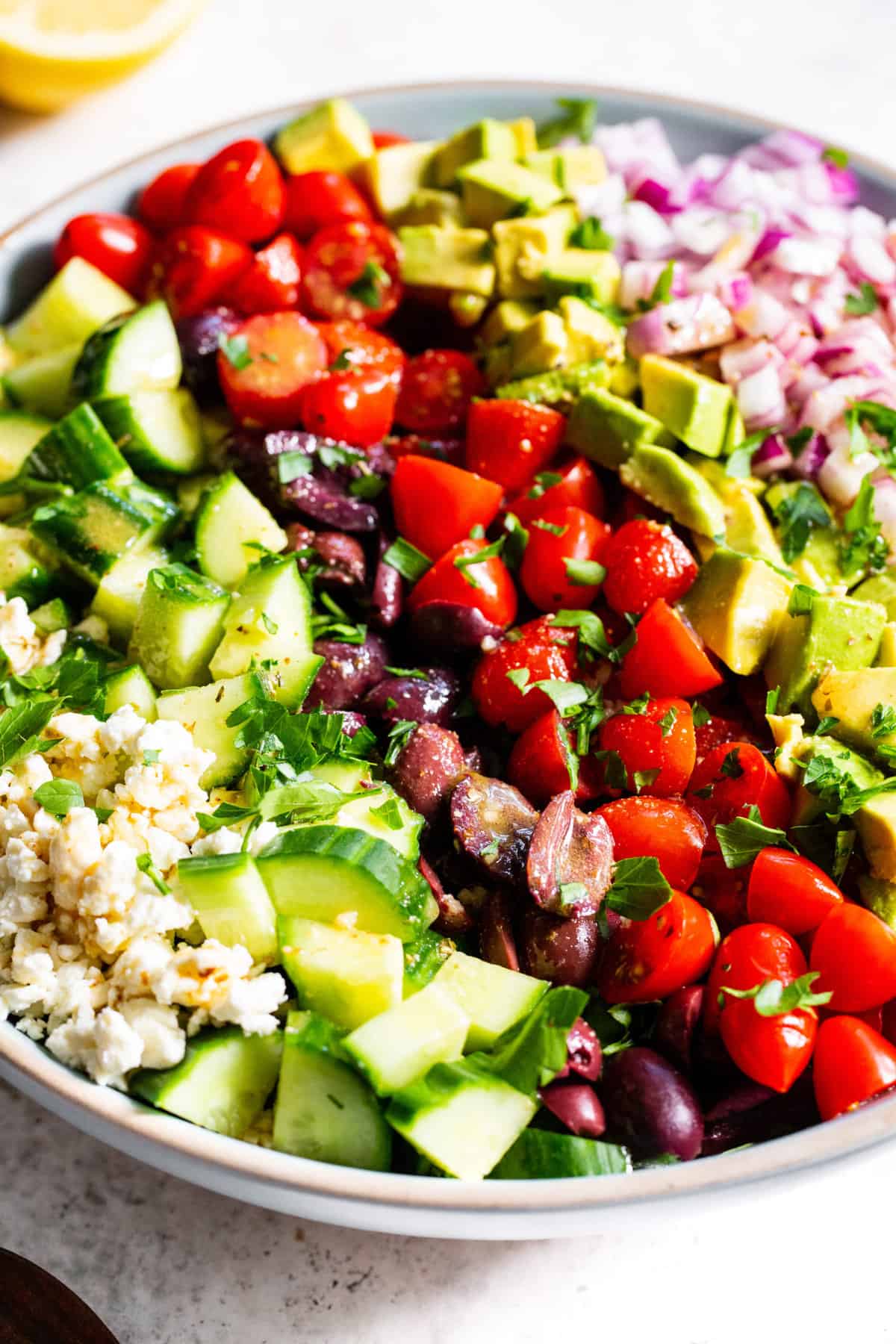 This mediterranean chopped salad has loads of veggies, a flavor packed vinaigrette and vegan feta cheese. It’s perfect to serve to guests, for BBQs, picnics or a light lunch. Make it a full meal by topping with chopped chicken or other protein. Paleo and vegan