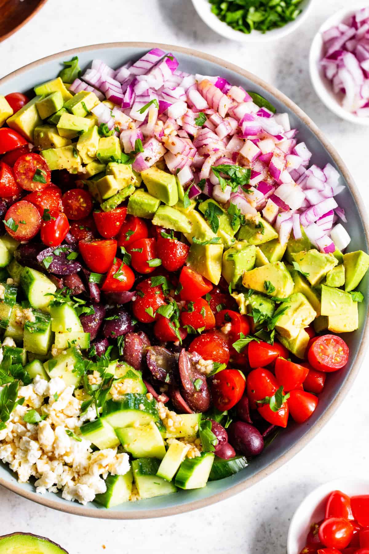 This mediterranean chopped salad has loads of veggies, a flavor packed vinaigrette and vegan feta cheese. It’s perfect to serve to guests, for BBQs, picnics or a light lunch. Make it a full meal by topping with chopped chicken or other protein. Paleo and vegan