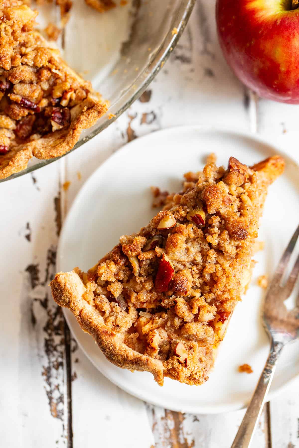 Overhead view of homemade apple crumble pie with golden crumb topping.