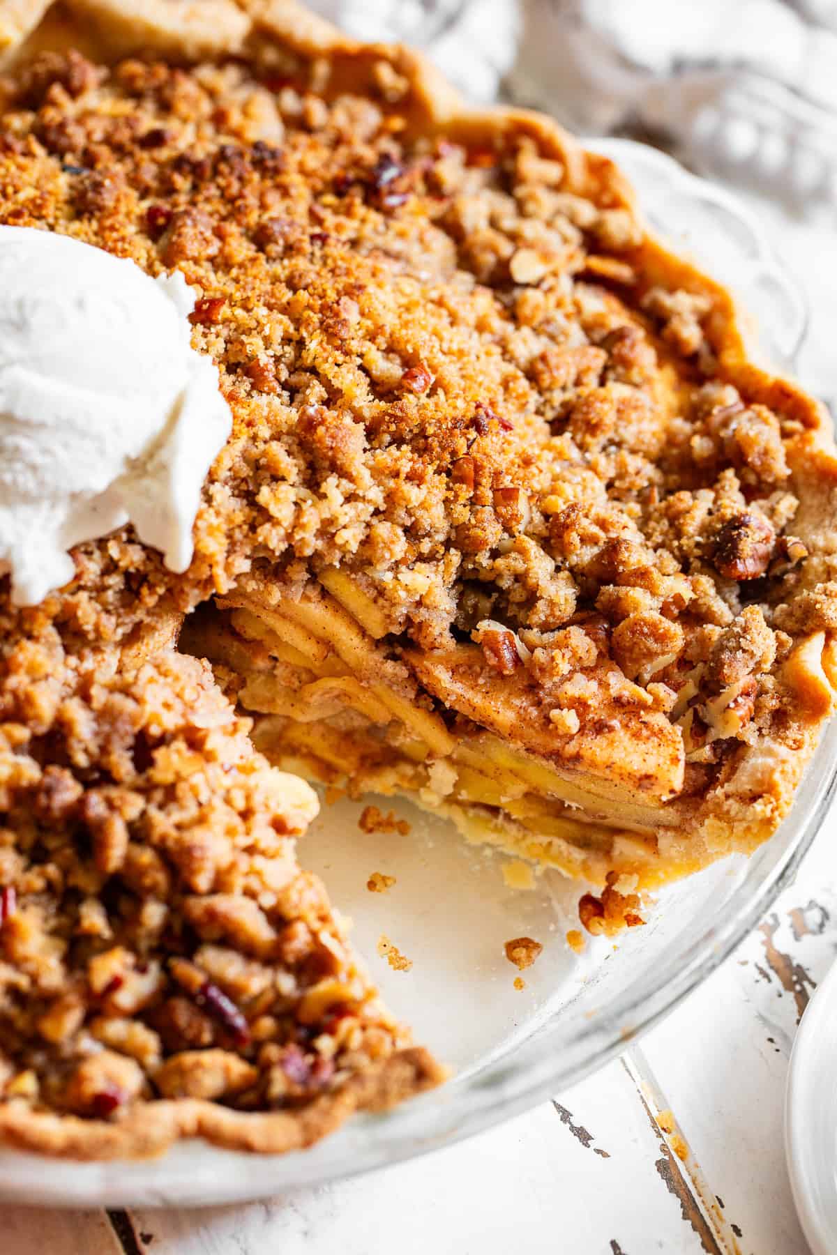 Close-up of paleo apple crumble pie with juicy cinnamon apples and chunky almond flour crumble.