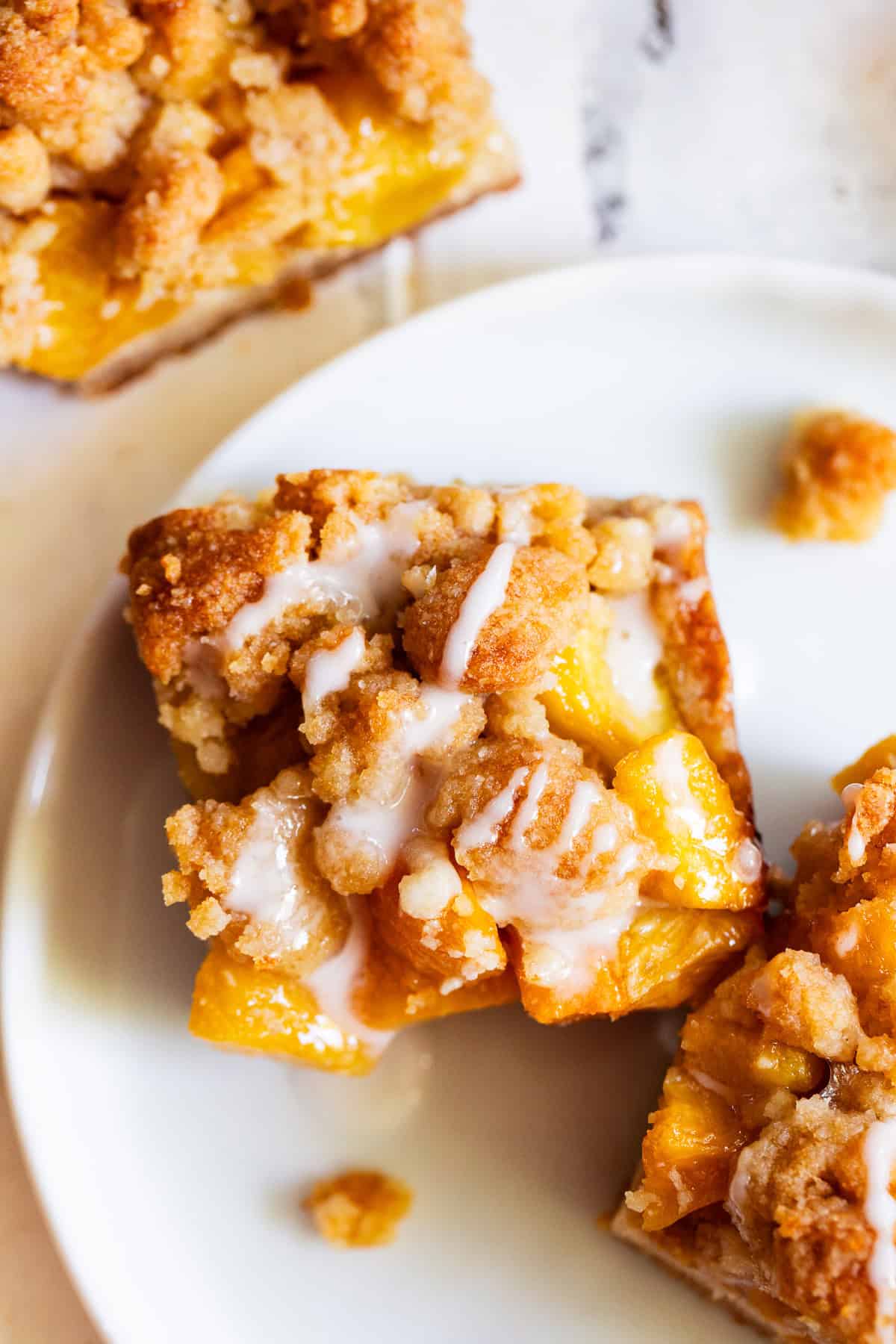 Peach crumble bars with buttery almond flour crust and golden crumb topping